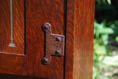 Close-up hand hammered hinge hardware.